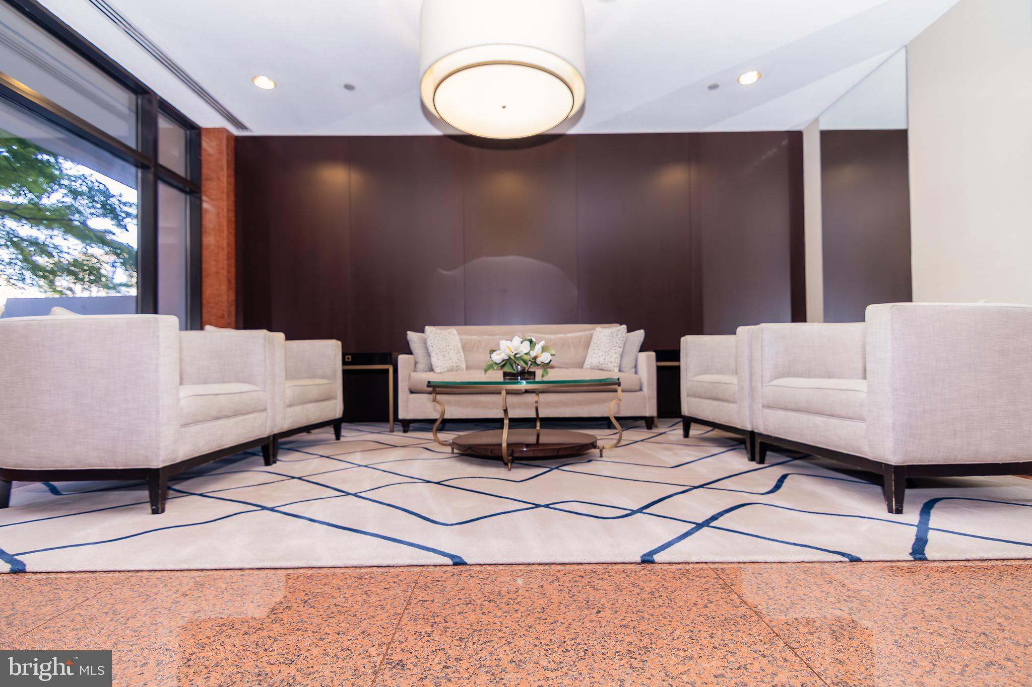 1530 Key Boulevard, Unit 205 Arlington, VA 22209 - Photo 9 of 33 a living room with a bed furniture and a large window