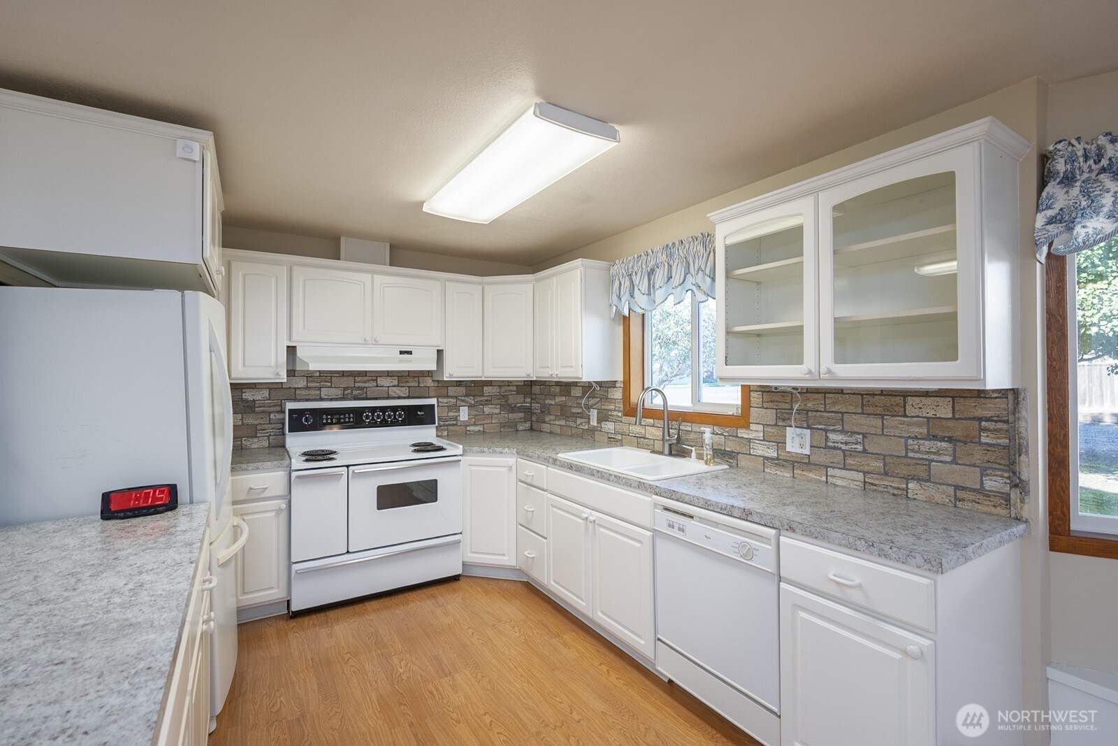 221 K Street Southwest Quincy, WA 98848 - Photo 16 of 38 a kitchen with white cabinets and white appliances