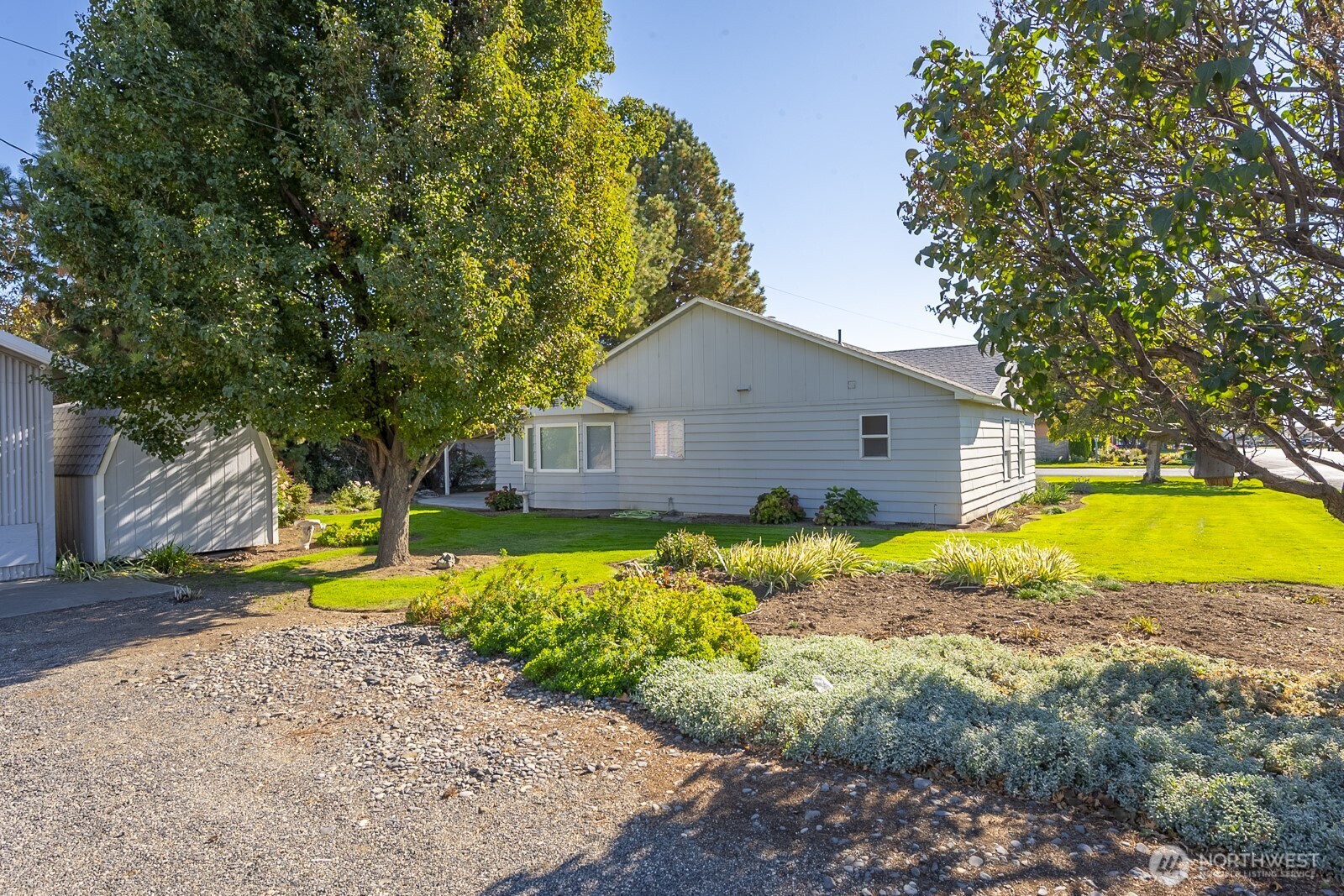 221 K Street Southwest Quincy, WA 98848 - Photo 33 of 38 a view of a house with pool and lawn chairs under an umbrella