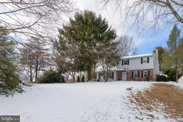 a view of a house with a snow in a yard