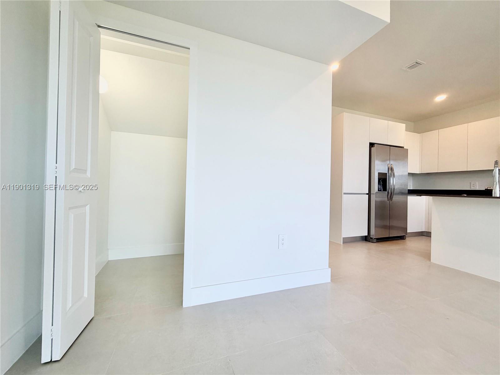 19113 Southwest 344th Terrace, Unit 19113 Homestead, FL 33034 - Photo 23 of 57 a view of a kitchen with a refrigerator a sink and a dishwasher