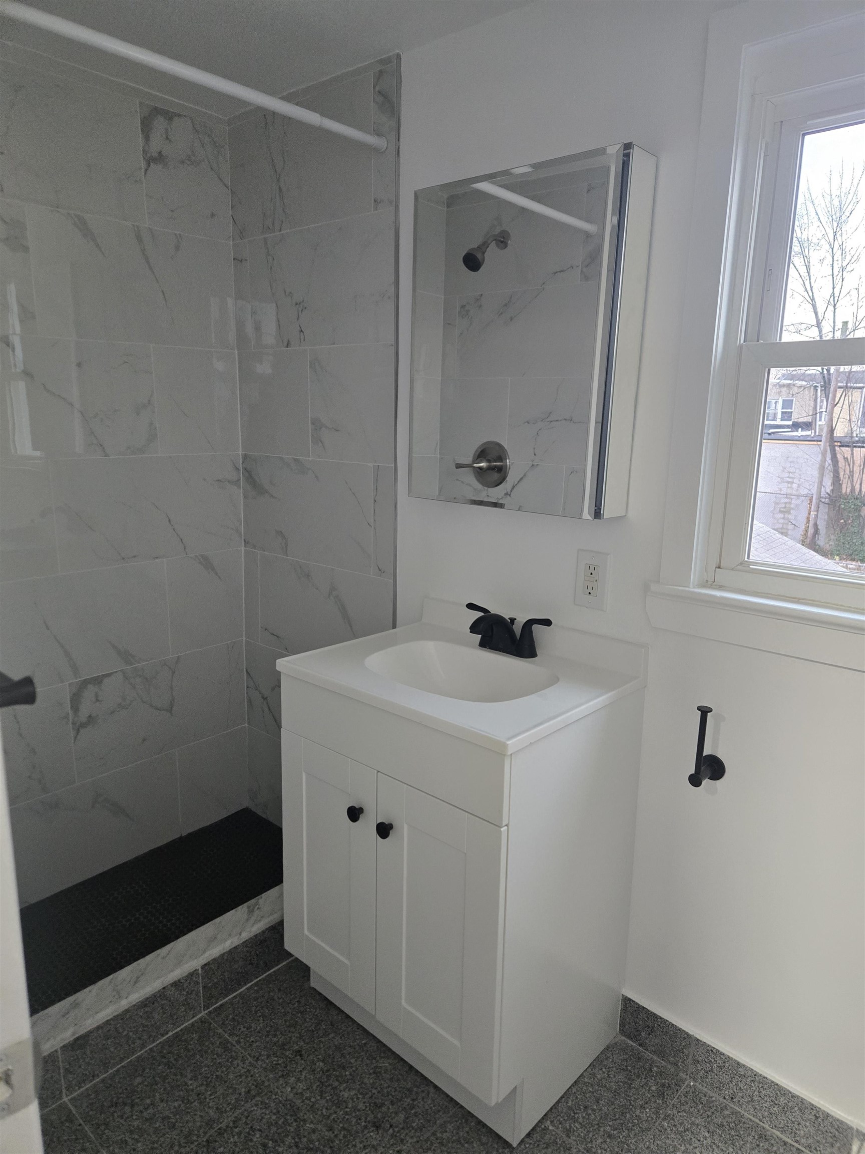 308 Lincoln Avenue, Unit 2 Lyndhurst, NJ 07071 - Photo 5 of 9 a bathroom with a sink a toilet and shower