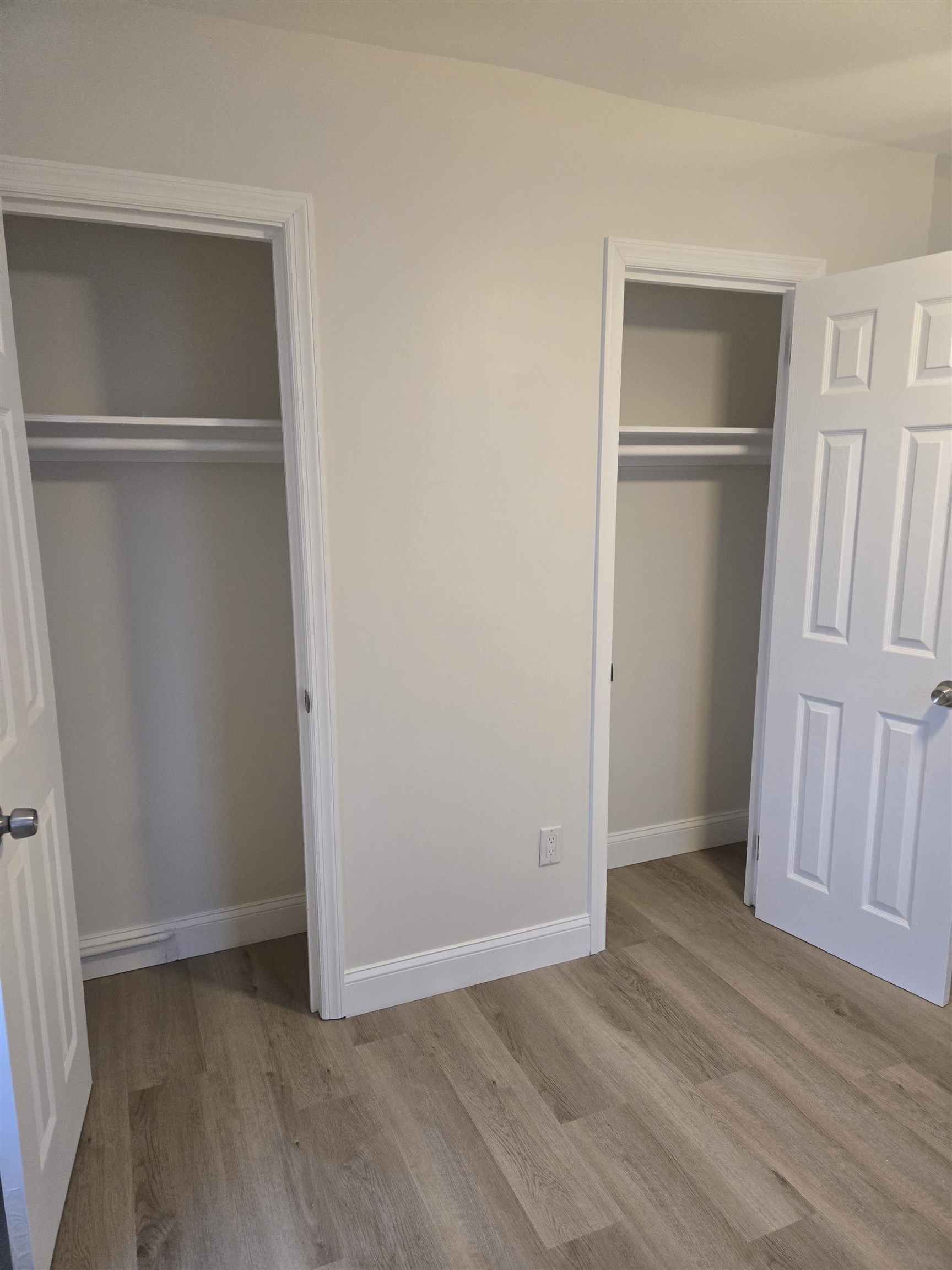 308 Lincoln Avenue, Unit 2 Lyndhurst, NJ 07071 - Photo 7 of 9 a view of an empty room with wooden floor and a window