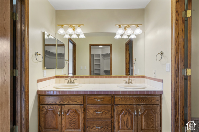 1373 Pheasant Ridge Circle Bountiful, UT 84010 - Photo 25 of 50 Primary bathroom with Dual vanity with integrated sinks, wood cabinetry, and a tile countertop