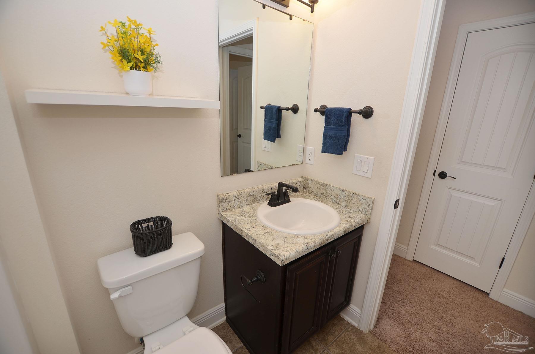 5709 Mill Stream Way Pace, FL 32571 - Photo 36 of 48 a bathroom with a sink toilet and mirror