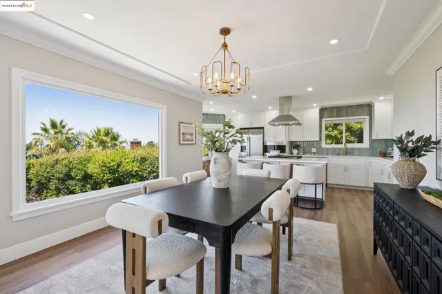 a view of a dining room with furniture and chandelier