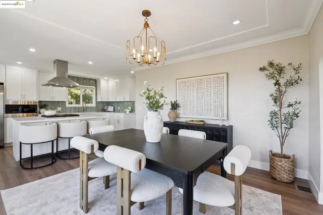 a kitchen with stainless steel appliances granite countertop a sink a refrigerator and a stove