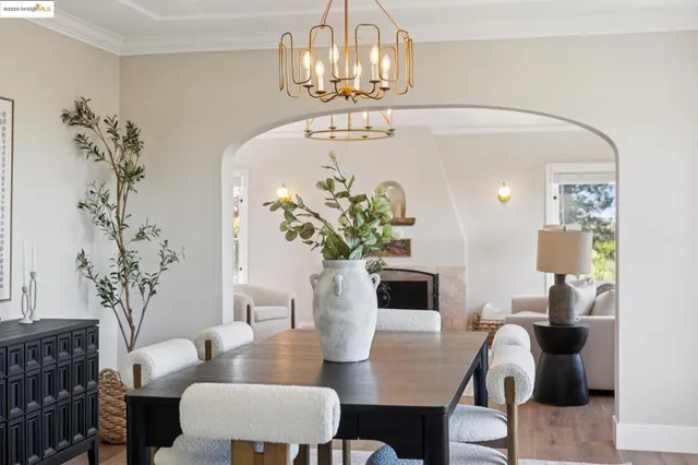 a kitchen with sink a stove and chairs with wooden floor