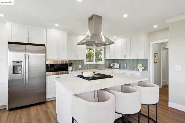 a kitchen with a stove a sink and a refrigerator