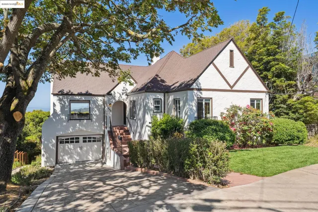 front view of a house with a tree