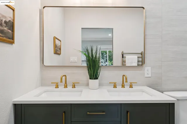 a bedroom with a bed and large windows