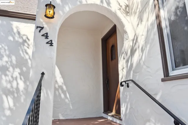 a living room with furniture chandelier and a fireplace