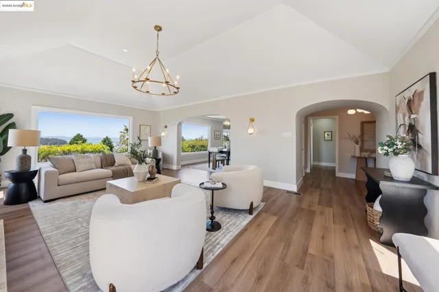 a living room with furniture a fireplace and a mirror