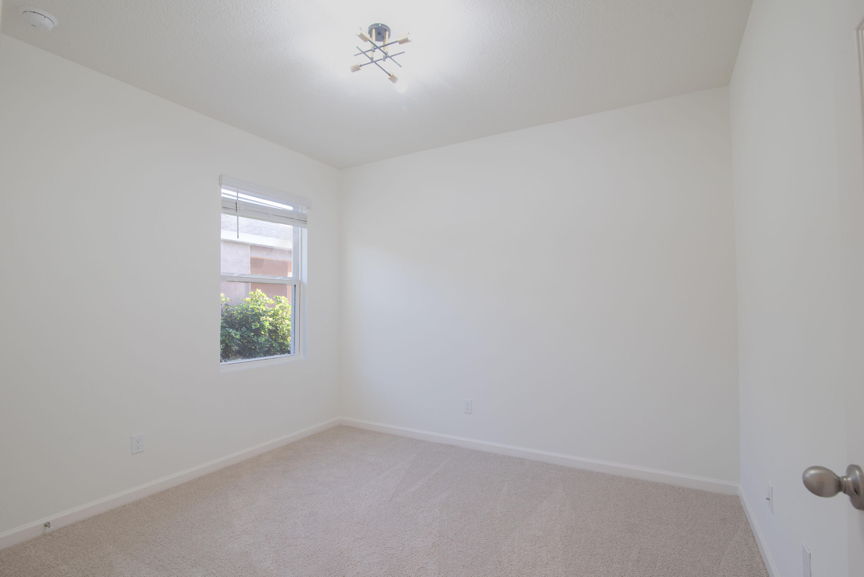 12152 Rimini Way Port St. Lucie, FL 34987 - Photo 12 of 24 a view of an empty room with a window
