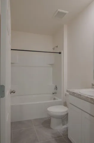 a bathroom with a toilet a sink and shower
