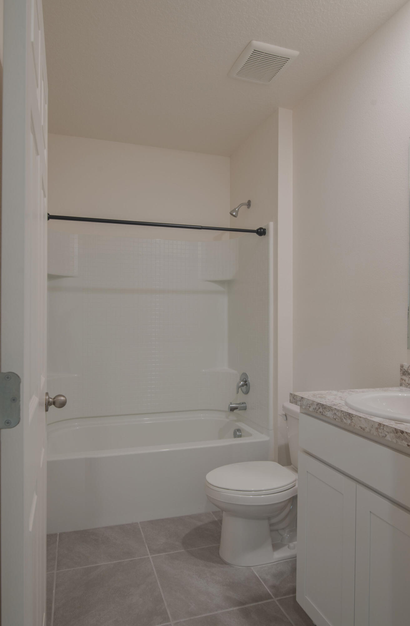12152 Rimini Way Port St. Lucie, FL 34987 - Photo 14 of 24 a bathroom with a toilet a sink and shower