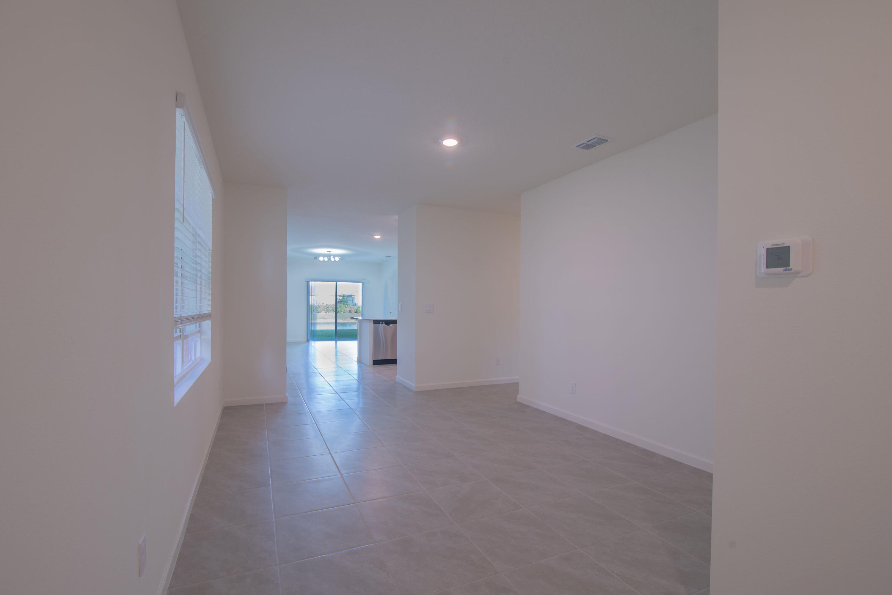 12152 Rimini Way Port St. Lucie, FL 34987 - Photo 15 of 24 a view of a big room with wooden floor and windows