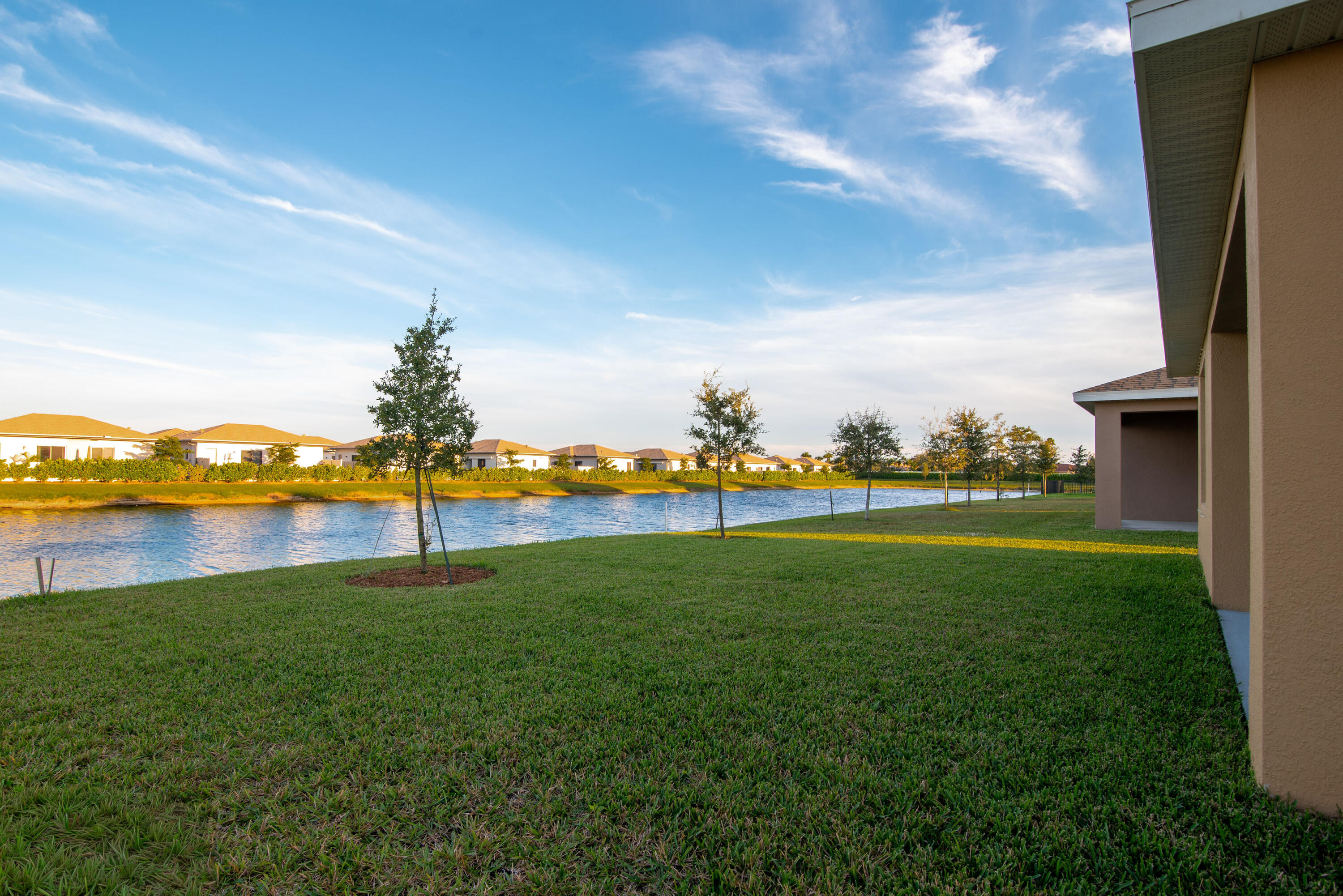 12152 Rimini Way Port St. Lucie, FL 34987 - Photo 19 of 24 a view of a lake with a big yard