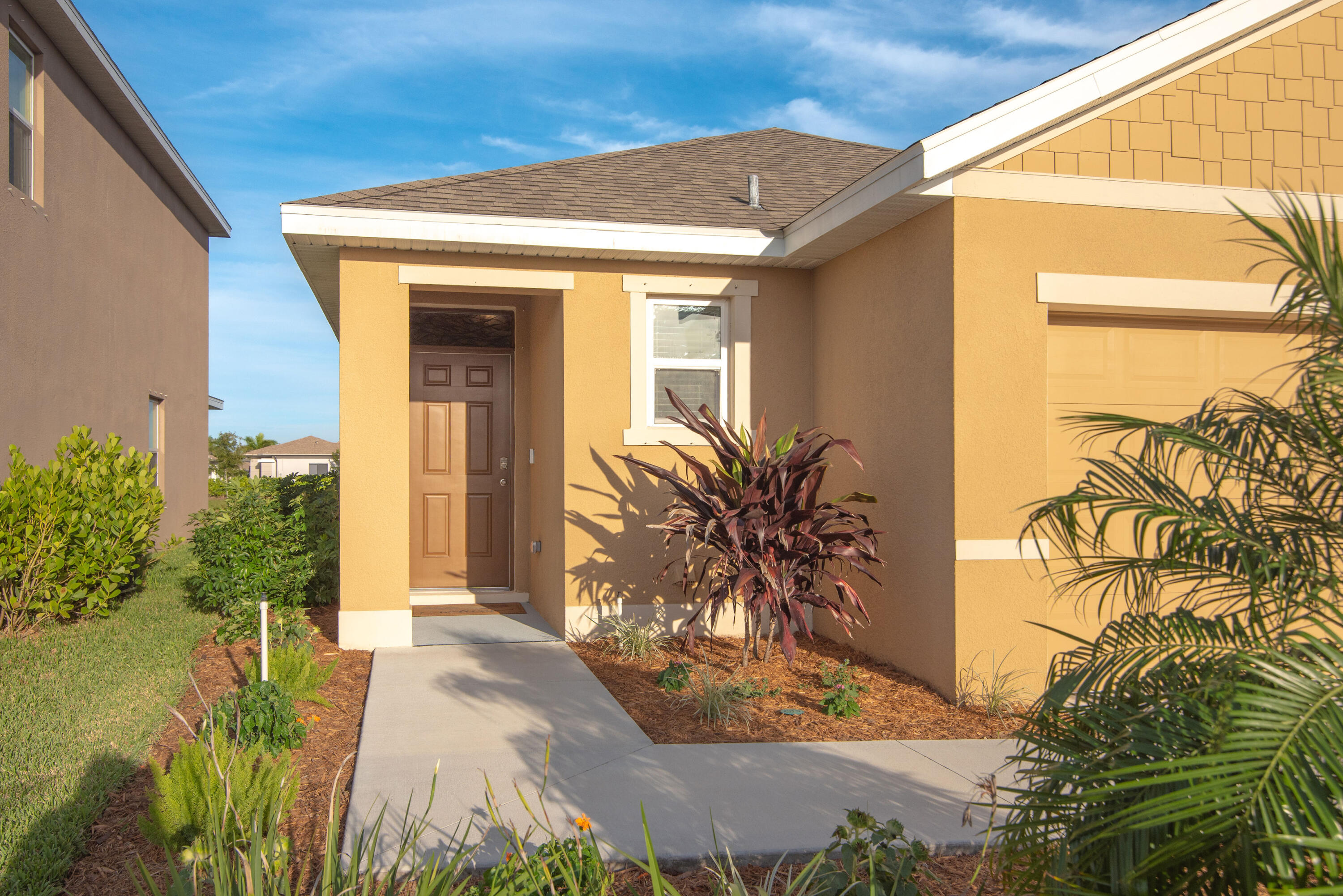 12152 Rimini Way Port St. Lucie, FL 34987 - Photo 23 of 24 a front view of a house with a yard
