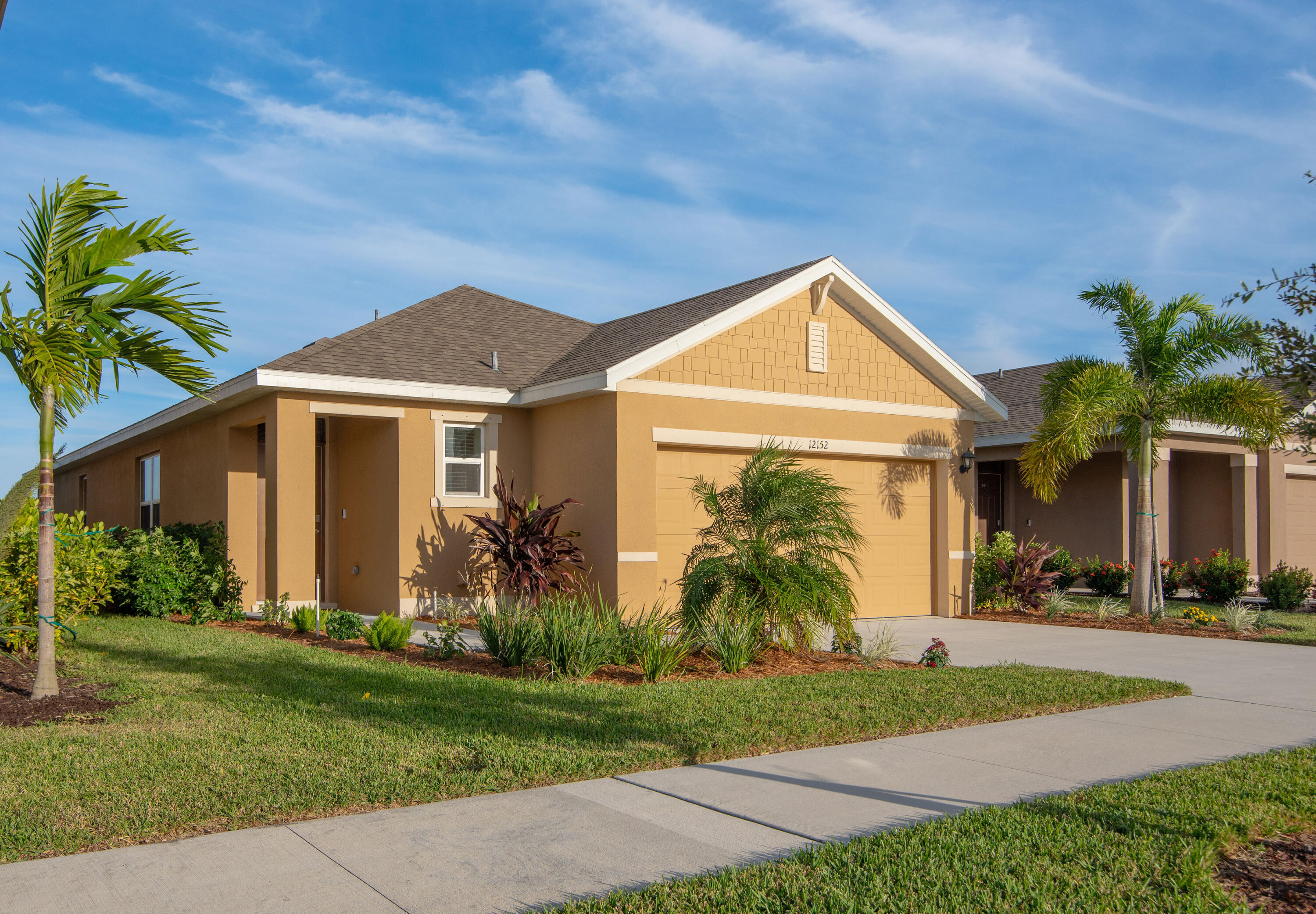 12152 Rimini Way Port St. Lucie, FL 34987 - Photo 24 of 24 a front view of a house with garden