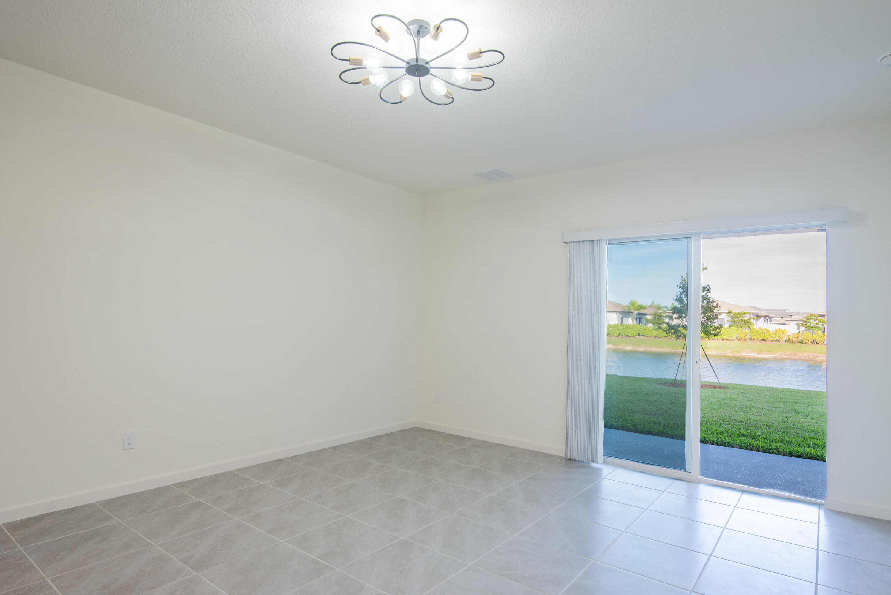 12152 Rimini Way Port St. Lucie, FL 34987 - Photo 5 of 24 a view of an empty room with a window