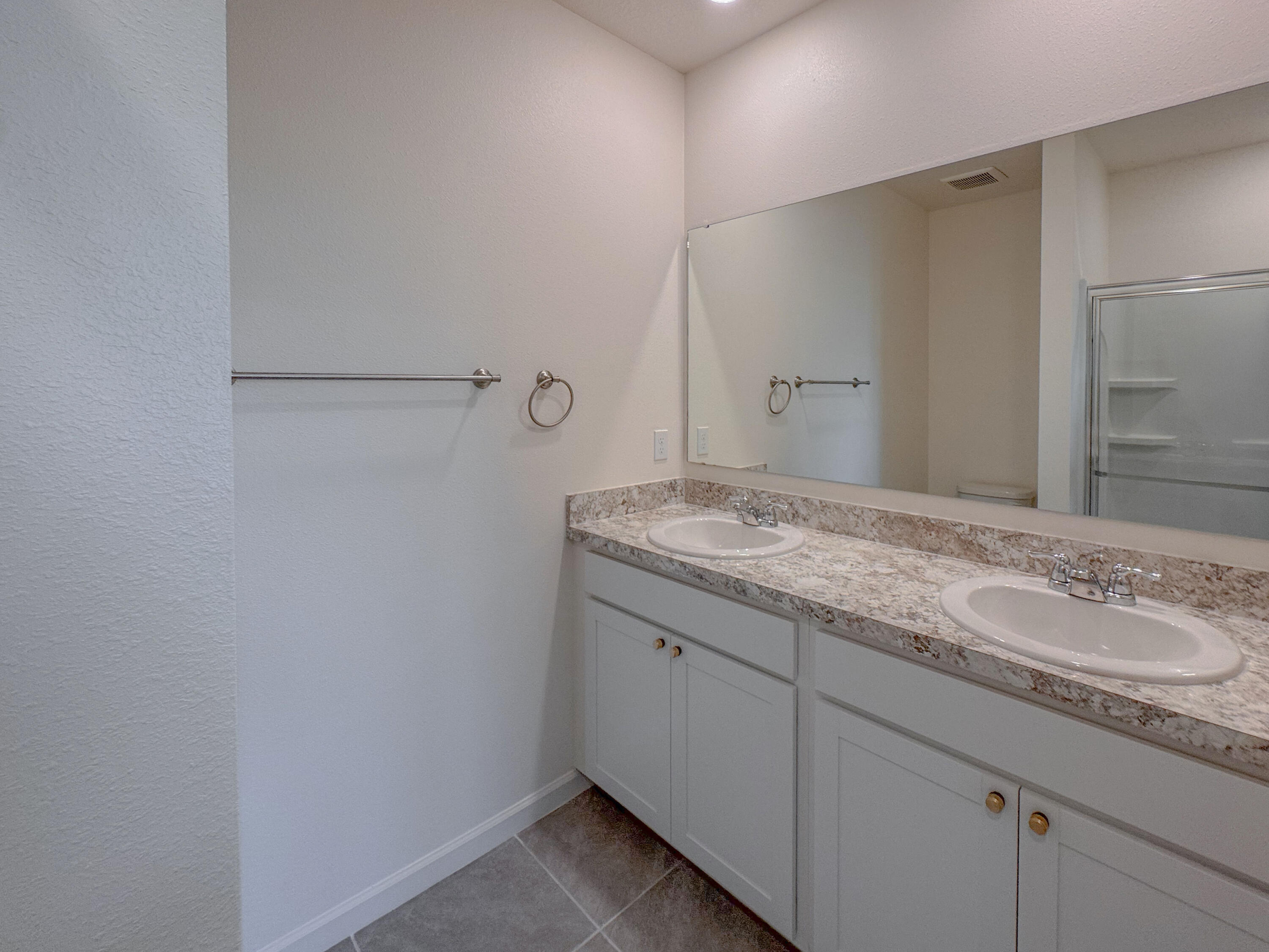 12152 Rimini Way Port St. Lucie, FL 34987 - Photo 8 of 24 a bathroom with a granite countertop sink and a mirror
