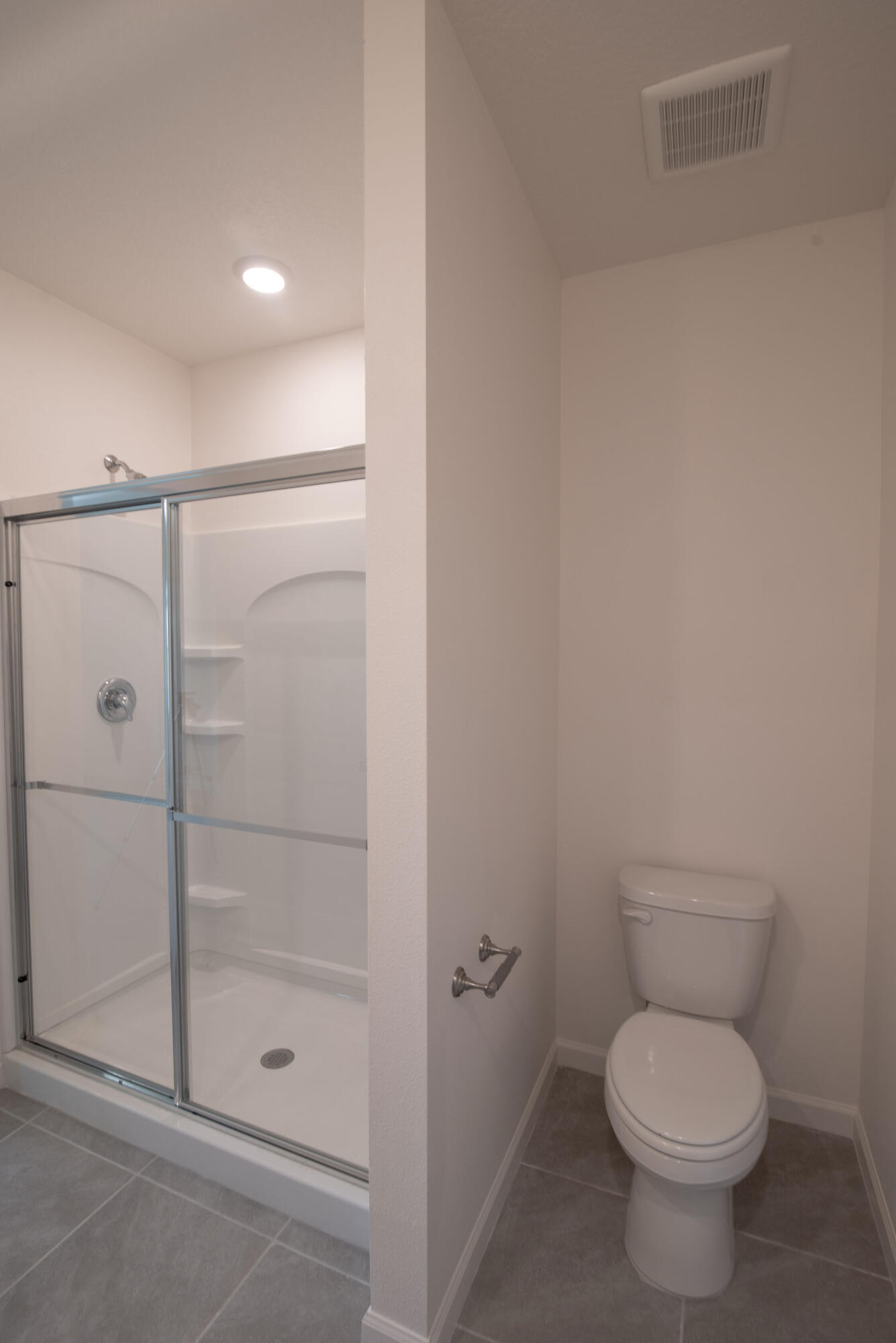 12152 Rimini Way Port St. Lucie, FL 34987 - Photo 10 of 24 a bathroom with a toilet and a shower