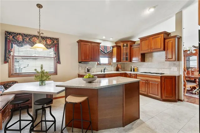 a kitchen with a refrigerator and stove