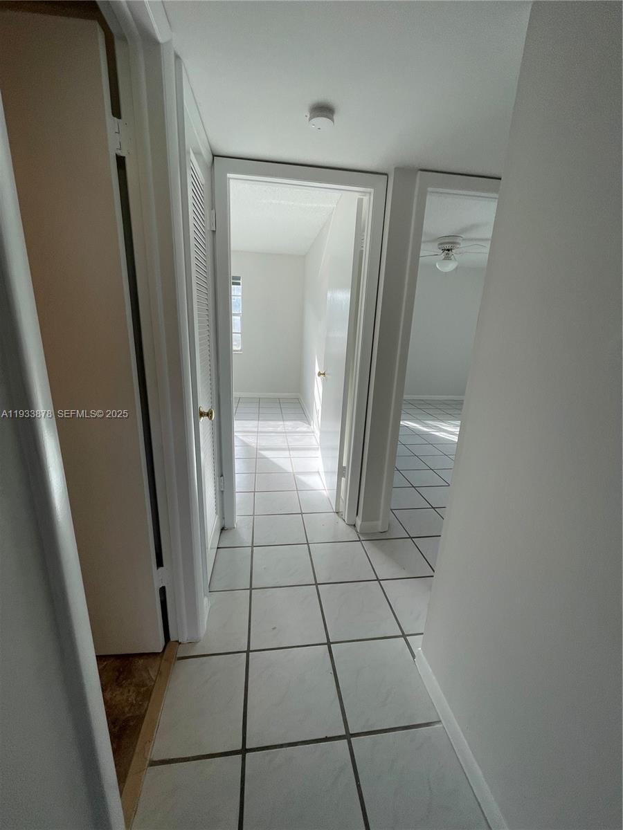 485 Flanders P, Unit 485 Delray Beach, FL 33484 - Photo 14 of 42 a bathroom with a glass door shower and a mirror