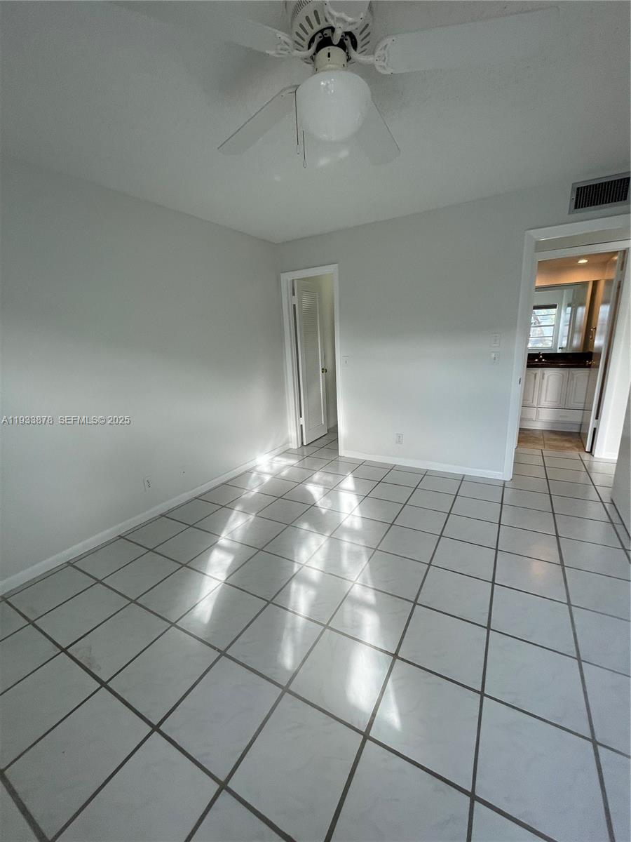 485 Flanders P, Unit 485 Delray Beach, FL 33484 - Photo 20 of 42 a view of an empty room and window