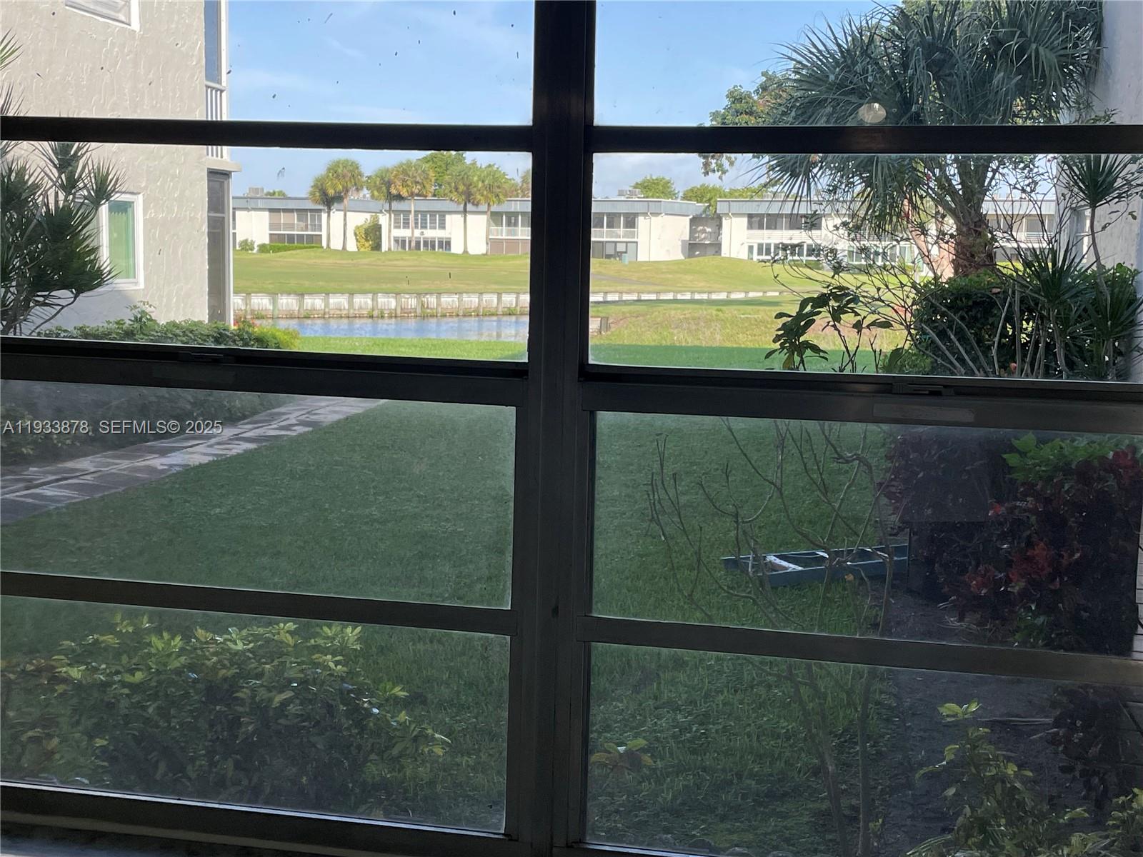 485 Flanders P, Unit 485 Delray Beach, FL 33484 - Photo 2 of 42 a view of lake from a window