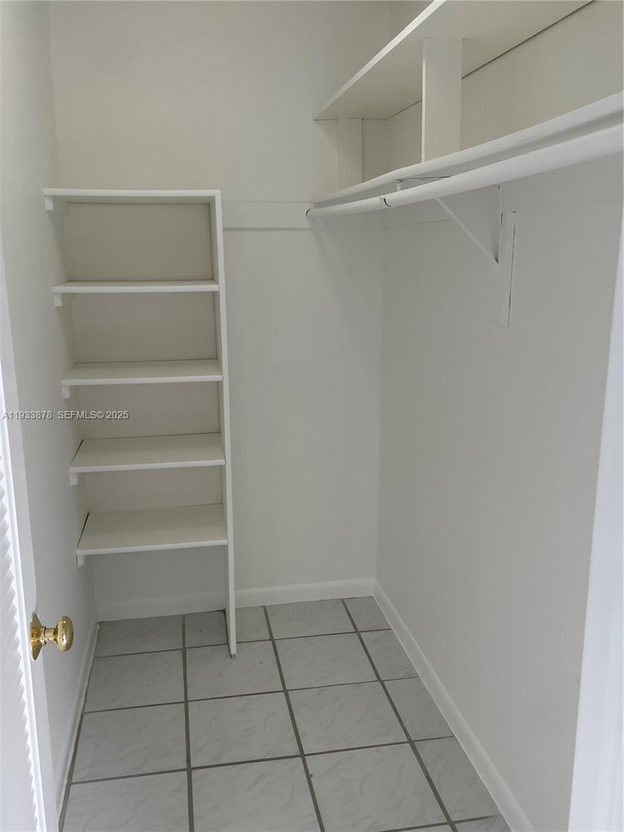 485 Flanders P, Unit 485 Delray Beach, FL 33484 - Photo 22 of 42 a view of an empty walk in closet
