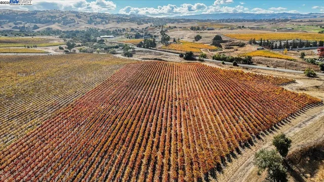 an outdoor view of swimming pool with lawn chairs and kitchen view
