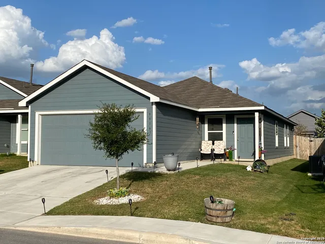 a backyard of a house with yard and garage