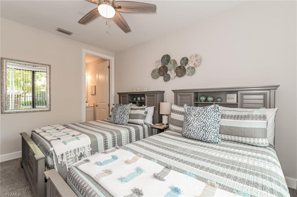 9636 Montelanico Loop, Unit 101 Naples, FL 34119 - Photo 6 of 10 Carpeted bedroom featuring a ceiling fan and connected bathroom