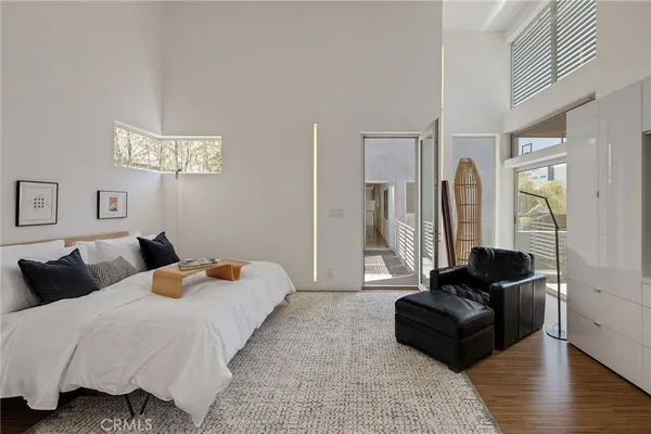 a view of walk in closet with clothes and washer