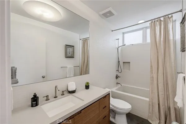 a view of a couches and dinning table in the balcony
