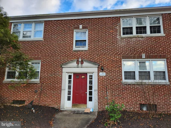 a brick house with a large windows