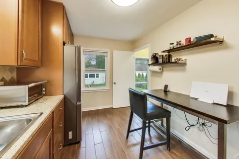 a kitchen with stainless steel appliances a stove a sink and a refrigerator