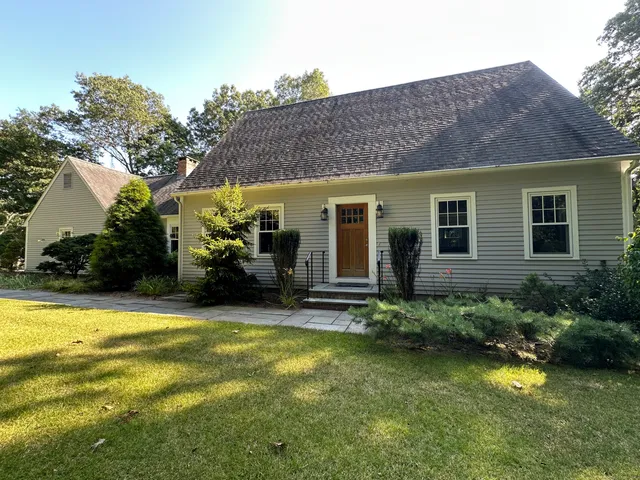 a view of a house with pool and sitting area
