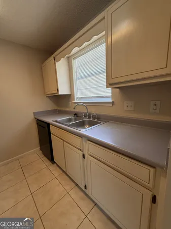 a kitchen with a sink and cabinets