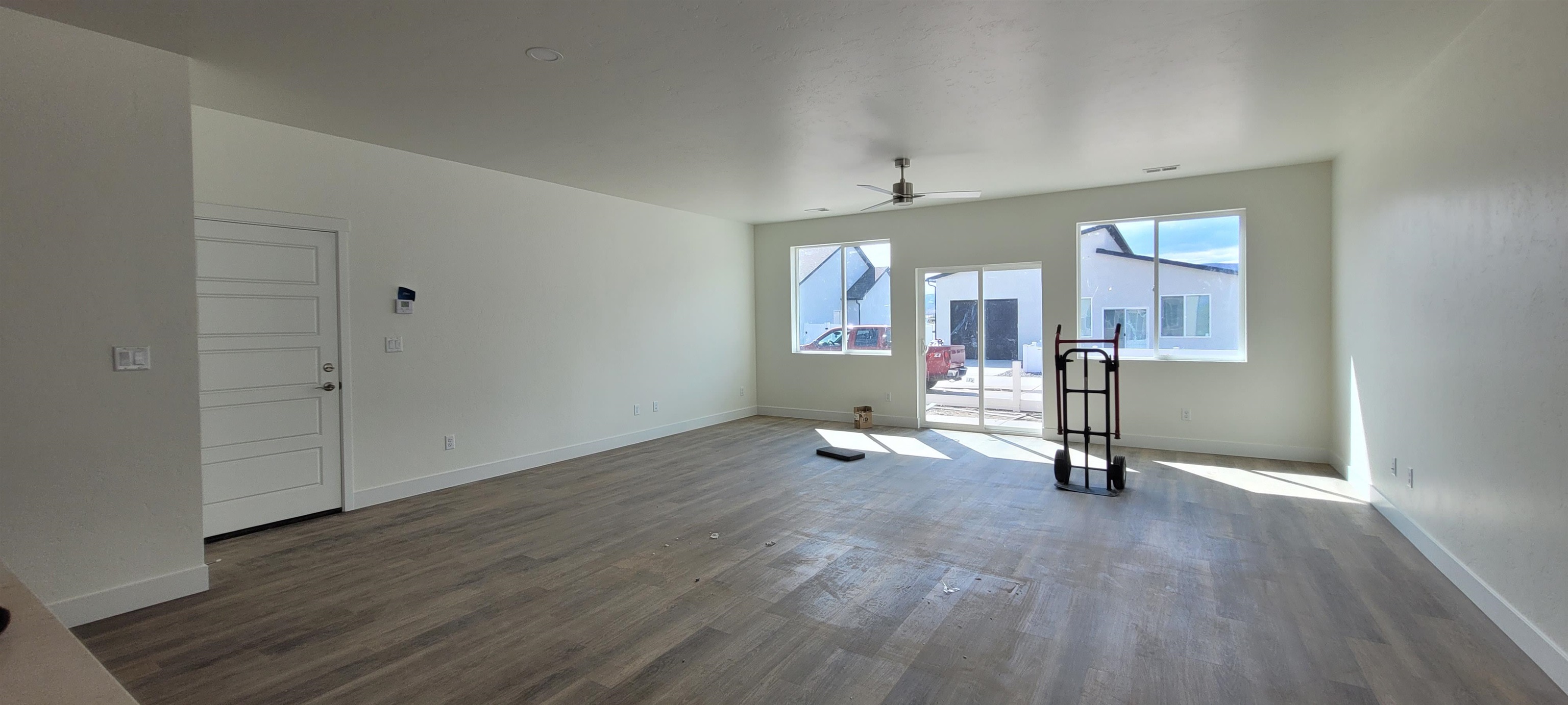 1674 Tungsten Way Fruita, CO 81521 - Photo 2 of 17 a view of a room with wooden floor and windows