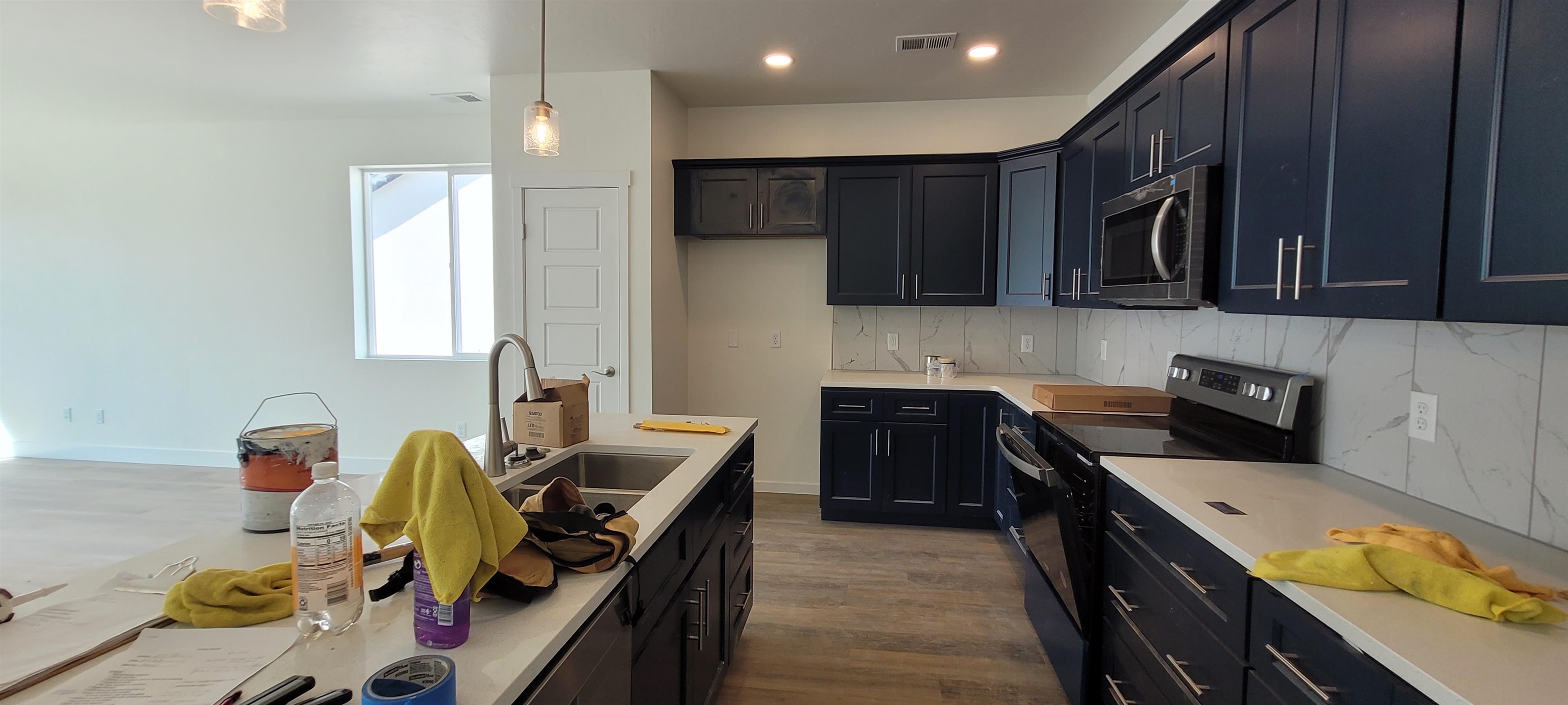 1674 Tungsten Way Fruita, CO 81521 - Photo 3 of 17 a kitchen with kitchen island granite countertop a sink appliances and cabinets