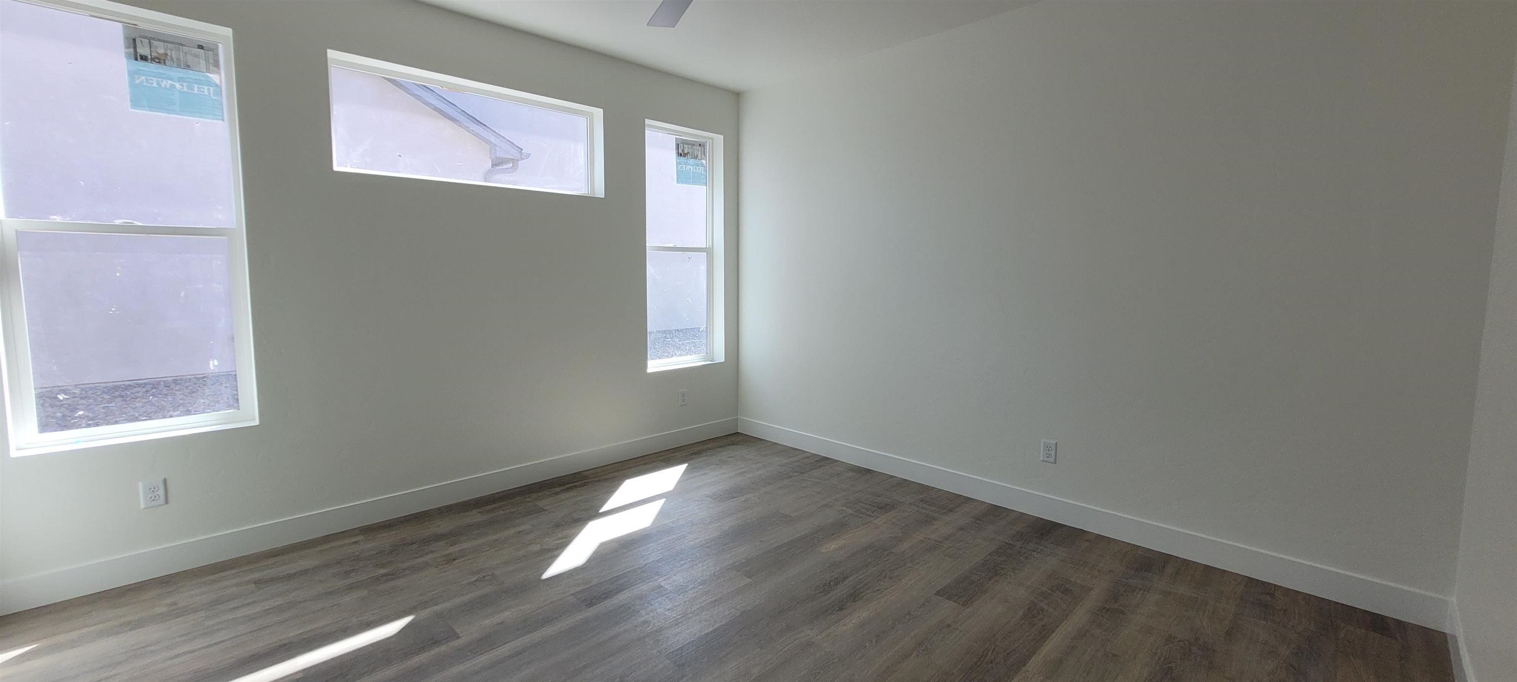 1674 Tungsten Way Fruita, CO 81521 - Photo 5 of 17 an empty room with wooden floor and windows
