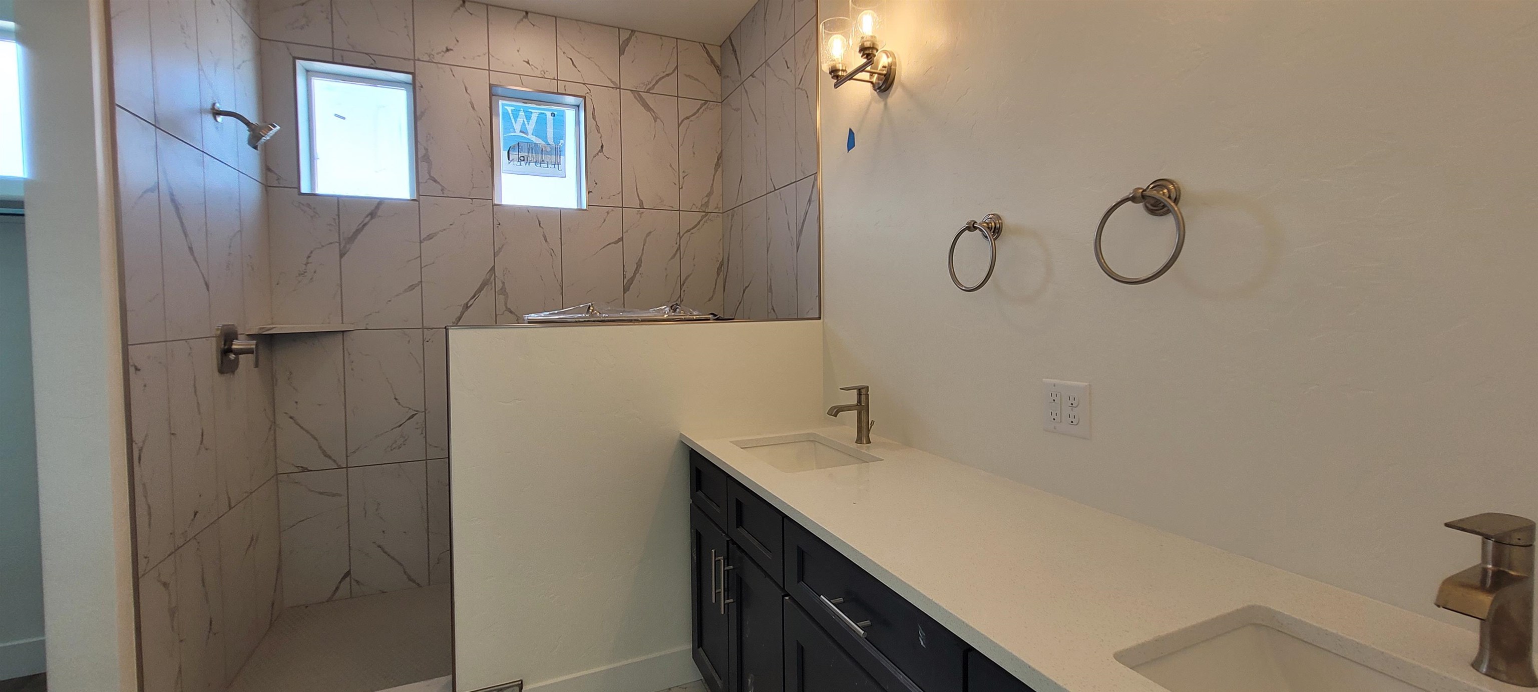 1674 Tungsten Way Fruita, CO 81521 - Photo 6 of 17 a bathroom with a granite countertop sink a toilet and with a mirror