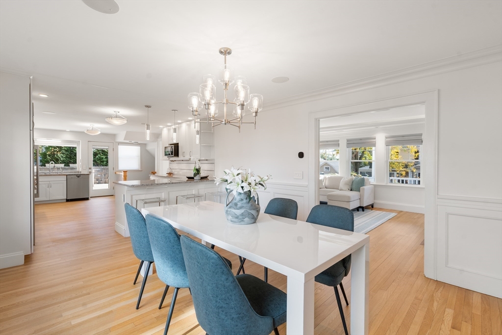152 Bellevue Road Watertown, MA 02472 - Photo 12 of 42 a view of a dining room and livingroom with furniture wooden floor a chandelier