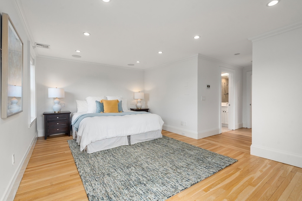 152 Bellevue Road Watertown, MA 02472 - Photo 17 of 42 a bedroom with a bed and wooden floor