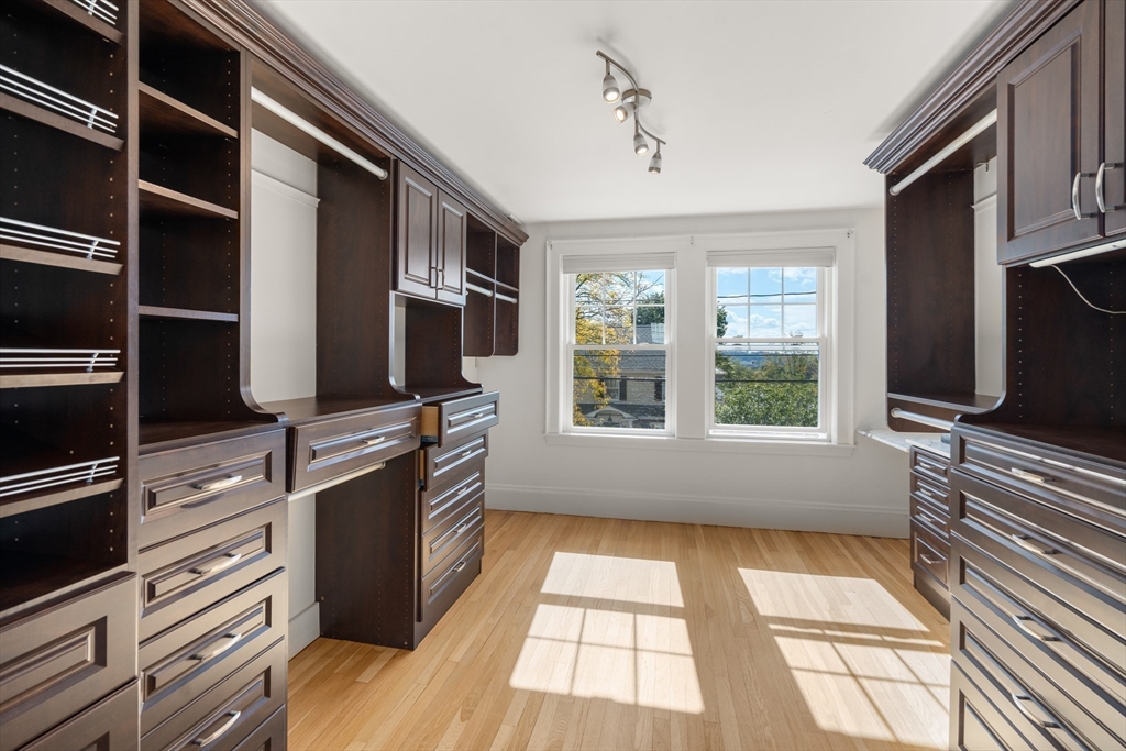 152 Bellevue Road Watertown, MA 02472 - Photo 19 of 42 a kitchen with stainless steel appliances granite countertop a stove and a microwave