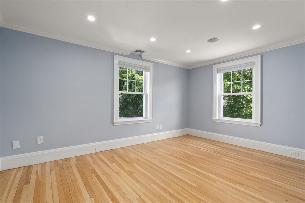 152 Bellevue Road Watertown, MA 02472 - Photo 22 of 42 a view of an empty room with wooden floor and a window