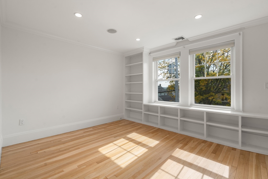 152 Bellevue Road Watertown, MA 02472 - Photo 23 of 42 a view of an empty room with wooden floor and a window